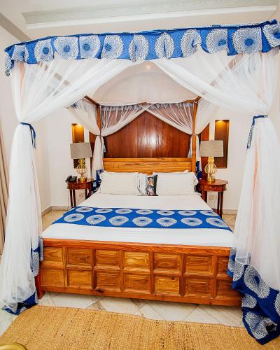 a bedroom with a bed with a canopy at The Seyyida Hotel and Spa in Zanzibar City