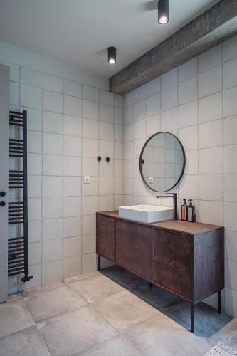 a bathroom with a sink and a mirror at Nima Residences in Paleros