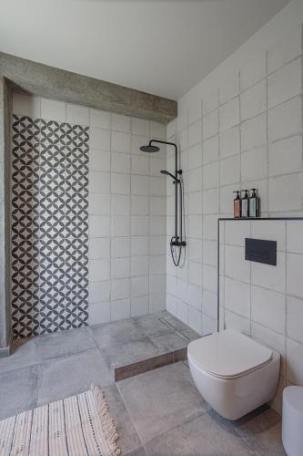 a bathroom with a shower and a toilet in it at Nima Residences in Paleros
