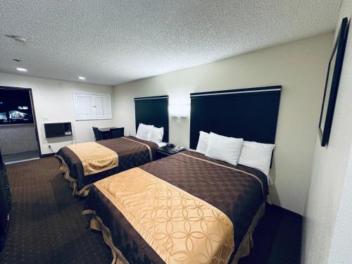 a hotel room with two beds in a room at Americas Best Value Inn Calimesa in Calimesa