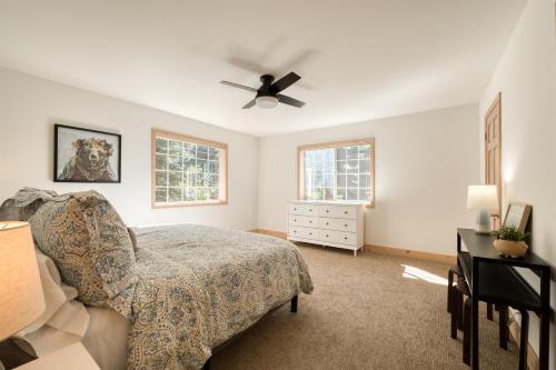 a bedroom with a bed and a ceiling fan at Knotty and Nice - 4BR w Private Hot Tub, Close to Lake in Tahoe Vista