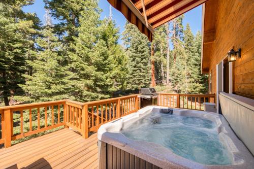 a hot tub on the deck of a cabin at Knotty and Nice - 4BR w Private Hot Tub, Close to Lake in Tahoe Vista