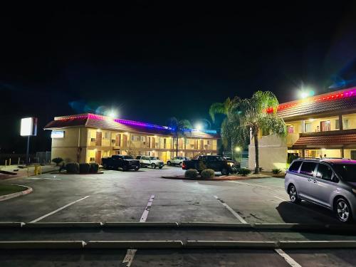 a parking lot in front of a hotel at night at Americas Best Value Inn Calimesa in Calimesa