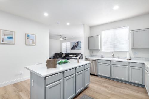 a kitchen with white cabinets and a counter top at San Michelle Luxury Escape -Mesa in Mesa