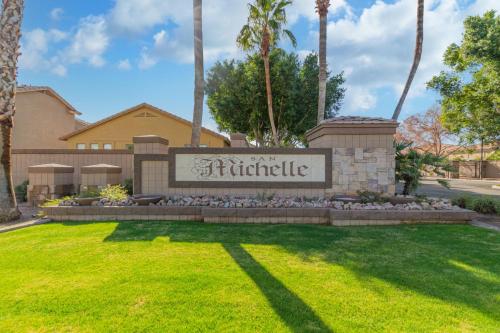 a sign in a yard in front of a building at San Michelle Luxury Escape -Mesa in Mesa