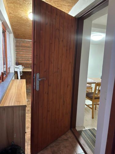 a wooden door in a room with a table at Guesthouse Trnčín in Mladá Boleslav