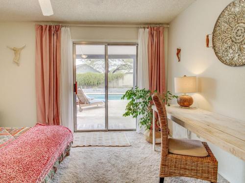 a bedroom with a desk and a bed and a window at Royale Living in the Heart of Phoenix in Glendale