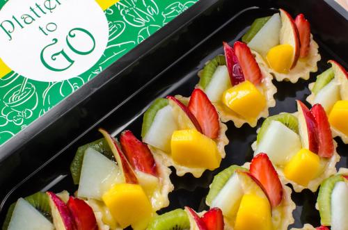 a tray filled with fruit snacks on a table at Holiday Inn & Suites Makati by IHG in Manila