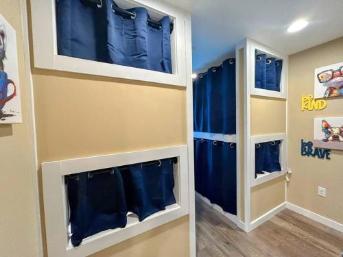 a room with blue curtains in a room with a hallway at Urban Retreat Downtown Gem Walk Everywhere Train View Mountain View Near National Park Entrance in Bryson City