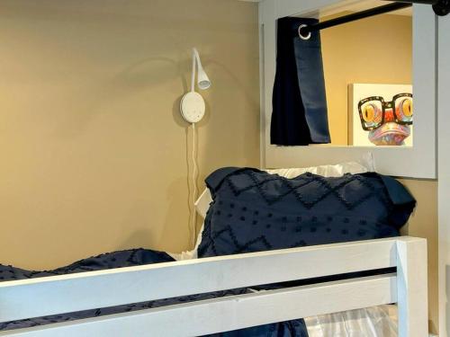 a bedroom with a bunk bed with a mirror at Urban Retreat Downtown Gem Walk Everywhere Train View Mountain View Near National Park Entrance in Bryson City