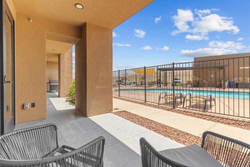 a balcony with chairs and a swimming pool at Vacation Rentals at Sand Hollow Resort in Hurricane