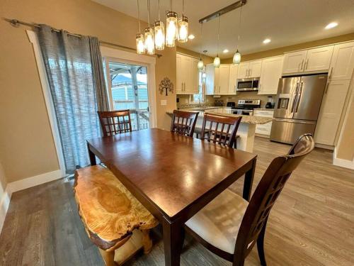 a dining room with a wooden table and chairs at Urban Retreat Downtown Gem Walk Everywhere Train View Mountain View Near National Park Entrance in Bryson City