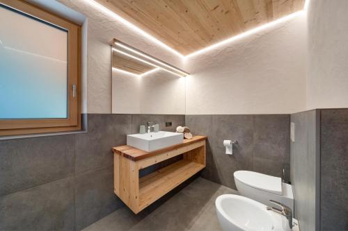 a bathroom with a sink and a toilet at Oberhaushof in Santa Valburga St. Walburg