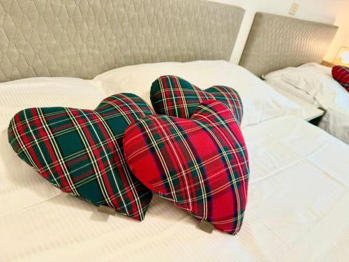 two hearts sitting on top of a bed at Villa Azzurro Blu in Lignano Sabbiadoro