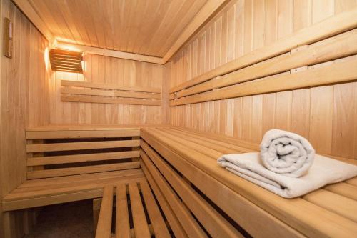 a sauna with wooden paneling and a towel at Lotusblume - 5 Sterne Ferienunterkunft mit möblierter Terrasse am Krakower See in Krakow am See
