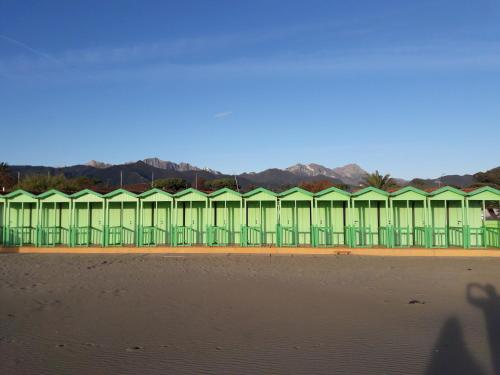 a building on the beach next to the water at Art Hotel Pietrasanta in Pietrasanta
