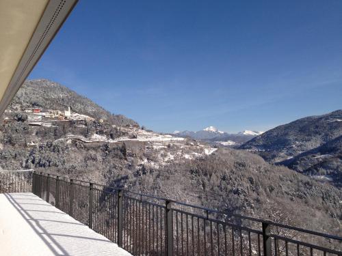 a view of a mountain from a balcony at Hostel L'Ost - Ostello di Grumes in Grumes