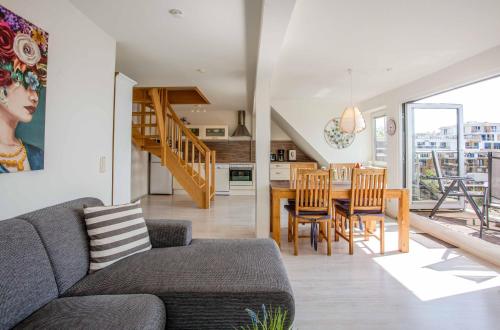 a living room with a couch and a table at MueritzAusblick - Altstadtidyll mit Hafenblick in Waren
