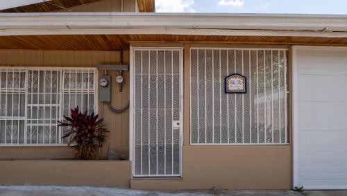 a house with white gates on the front door at Villa Paz in San José