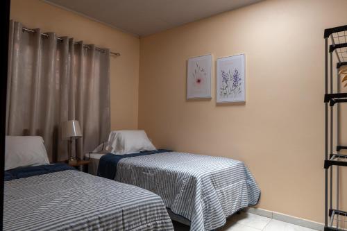 a hotel room with two beds and a window at Villa Paz in San José