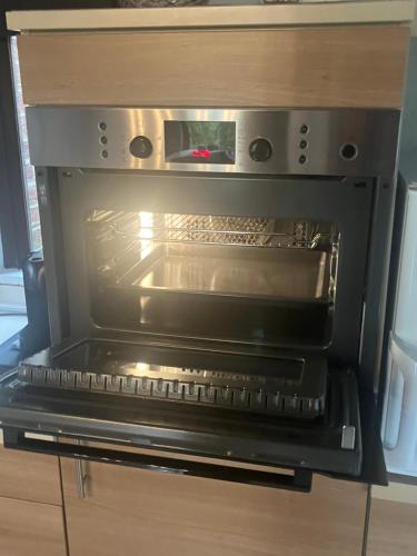 an oven with its door open in a kitchen at dar zaina in Blaimont