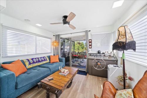 a living room with a blue couch and a table at Unique Houseboat Rental in Merritt Island