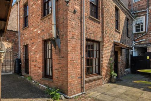 a brick building with windows on the side of it at Grade II Listed Cottage in Central Taunton in Taunton