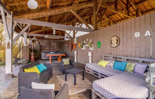 a patio with couches and chairs and a table at Nice Home In Savignac-Sur-Leyze in Savignac-sur-Leyze