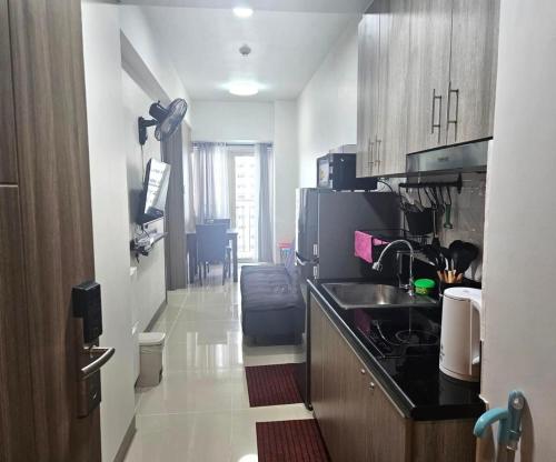 a kitchen with a sink and a counter top at Coast Residences - 1 Bedroom with Balcony near PICC, WTC, Star City & MOA in Manila