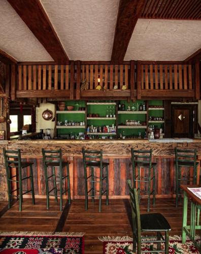 a bar with green bar stools in a room at Guesthouse Perunov Konak in Belgrade