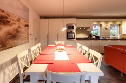 a dining room with a long table and chairs at Ferienhaus Daniela mit Terrasse und Garten in Silz