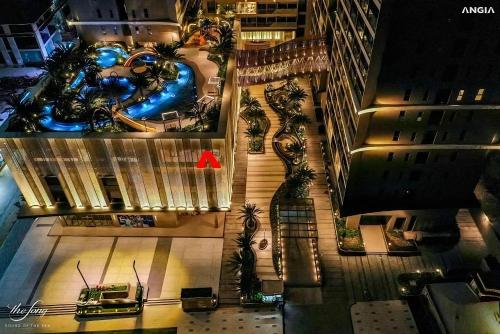 an aerial view of a building with palm trees at The Song Apartment 5 Stars Vung Tau - Căn Hộ Du Lịch 5 Sao Cạnh Biển - Dumin's Homestay in Vung Tau
