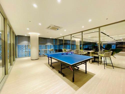 a ping pong table in the middle of a room at The Song Apartment 5 Stars Vung Tau - Căn Hộ Du Lịch 5 Sao Cạnh Biển - Dumin's Homestay in Vung Tau