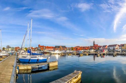 a group of boats docked in a harbor with buildings at Hafenoase mit Eckbalkon in Waren
