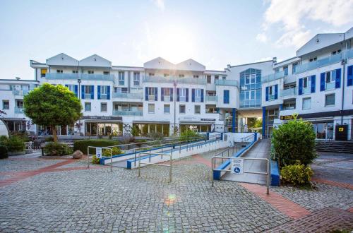 a large apartment building with a staircase in front of it at Meereswoge Zingst in Zingst