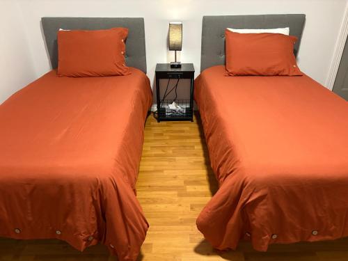 two beds sitting next to each other in a room at Maison d edouard in Saint-Antonin