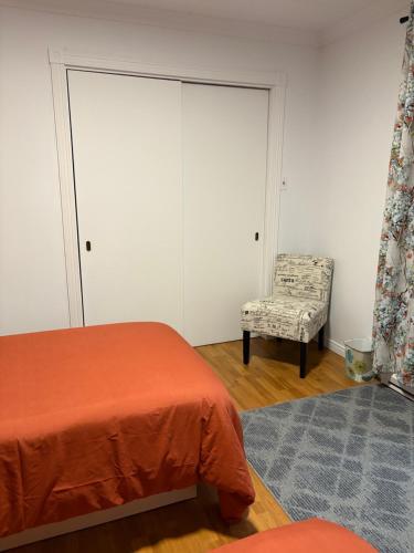 a bedroom with a bed and a chair and a window at Maison d edouard in Saint-Antonin