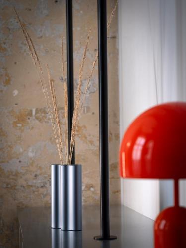 a metal vase with grass in it on a table at Hipsters Hotel in Thessaloniki