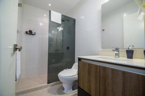 a bathroom with a toilet and a sink and a shower at Arezzo Forest View in Quito
