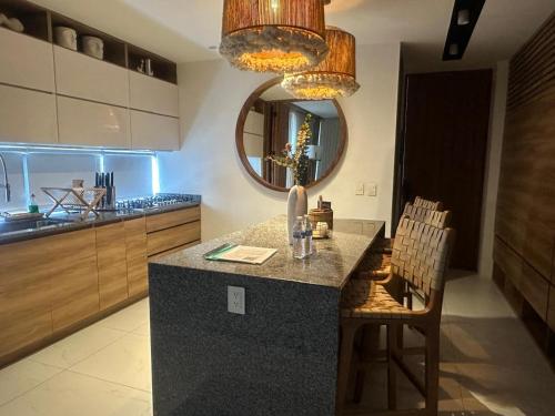 a kitchen with a counter with chairs and a mirror at Mako 54 in Puerto Vallarta
