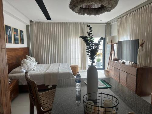a room with a table and a bedroom with a bed at Mako 54 in Puerto Vallarta