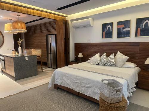 a bedroom with a large bed and a desk at Mako 54 in Puerto Vallarta