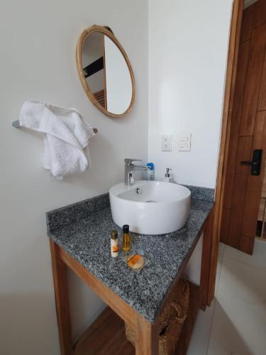 a bathroom with a sink and a mirror on a counter at Mako 54 in Puerto Vallarta