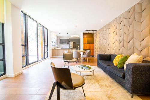 a living room with a couch and a table at Arezzo Forest View in Quito