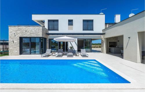 a swimming pool in front of a house at Villa Sole in Brtonigla