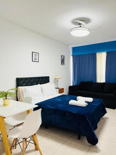 a bedroom with a bed and a table and a couch at Studio Apart 410 in Buenos Aires