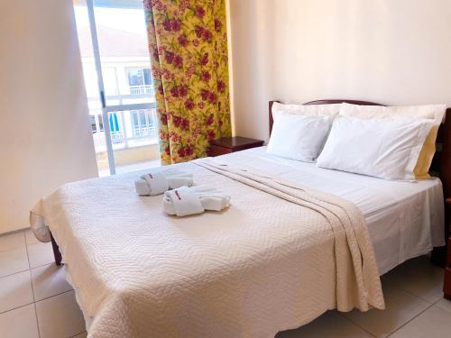 a hotel room with a bed with towels on it at Planet Pé na Areia PDD in Aquiraz