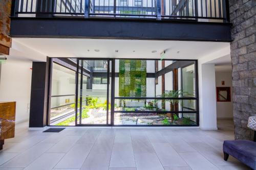 an open living room with a large glass door at Arezzo Forest View in Quito