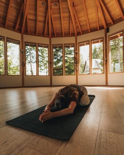 a man laying on a yoga mat in a room at The Sentinel in Kaslo