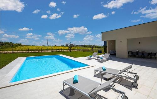 a swimming pool with lounge chairs and a patio at Villa Estate in Brtonigla